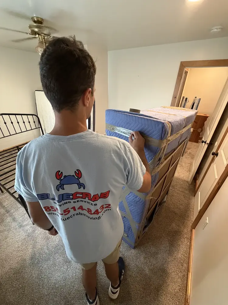 Movers in Crystal City. Blue Crab crew loading packed inventory and dollies in Arlington.